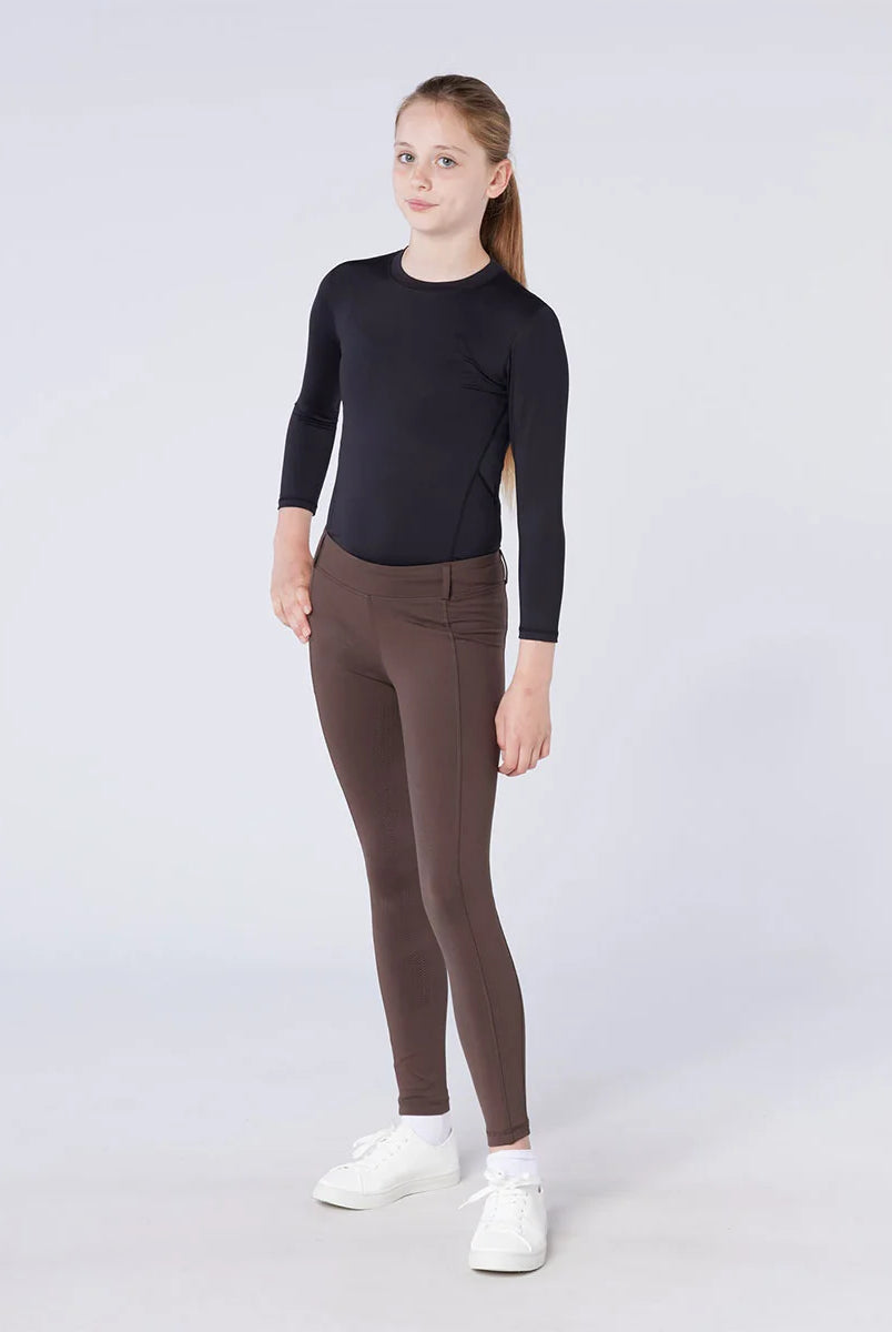 CAMEO All Season Riding Tights in Chocolate Brown worn by a junior rider, featuring a high-rise core-supporting waistband and 4-way compression stretch. These technical equestrian leggings include a thermal brushed lining and full-seat silicone chevron grip for security and comfort in the UK.