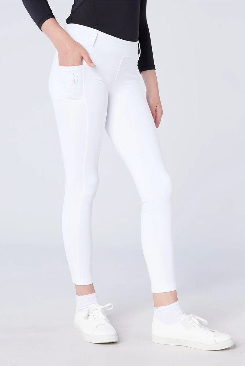 CAMEO All Season Riding Tights in White featuring a deep ergonomic thigh smartphone pocket for competition use. Worn by a junior rider, these technical equestrian leggings include a high-rise core-supporting waistband, thermal brushed lining, and full-seat silicone grip for show-day performance.