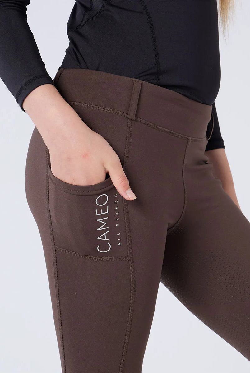 CAMEO All Season Riding Tights in Chocolate Brown featuring a deep ergonomic drop-in smartphone pocket and reflective branding. This close-up highlights the high-rise compressive waistband, reinforced belt loops, and technical 4-way stretch fabric engineered for athletic performance and yard durability.