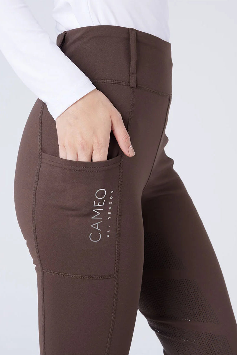 CAMEO All Season Tights in Chocolate Brown featuring a deep ergonomic thigh smartphone pocket and high-rise core-supporting waistband. These technical equestrian riding tights are designed with 4-way compression stretch, thermal brushed lining, and reinforced belt loops for elite performance.