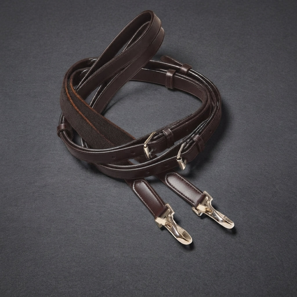 A coiled dark brown leather side rein strap with silver metal snap hooks and a textured brown fabric section, displayed on a dark gray background.