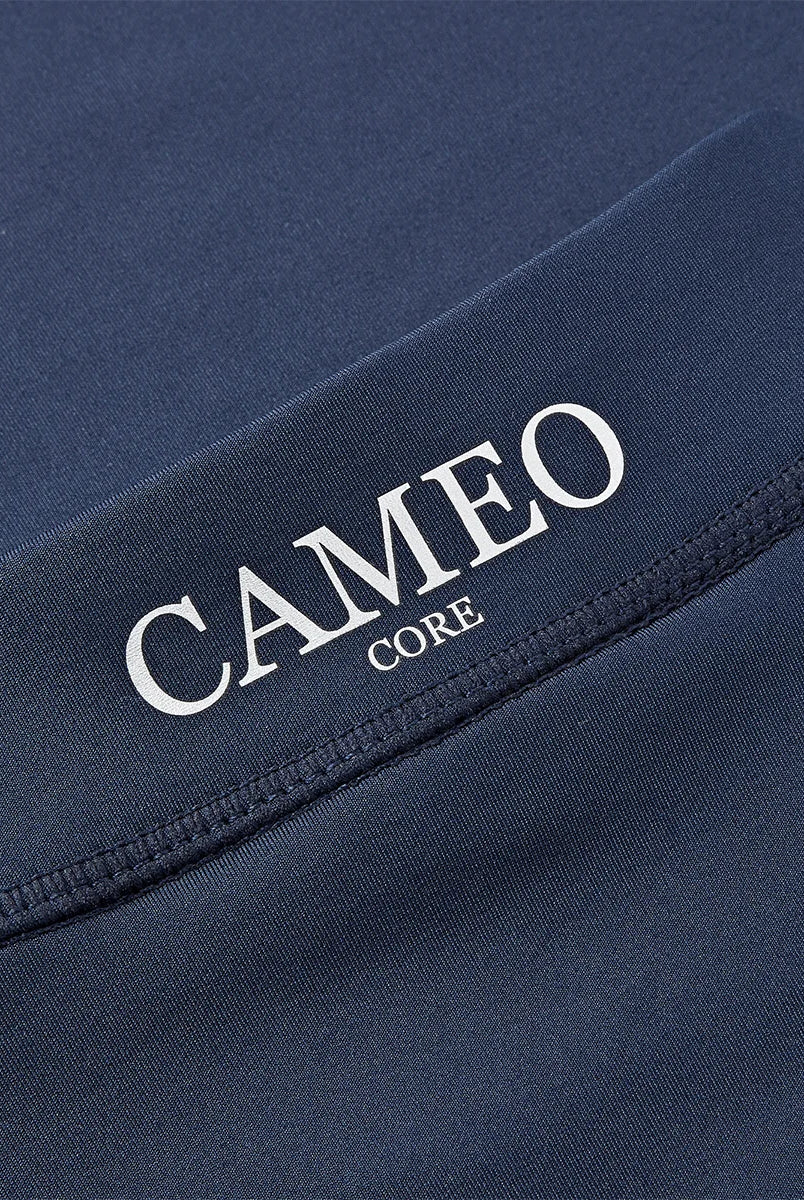 CAMEO Core Collection Baselayer in Navy showing a macro close-up of the reflective silver CAMEO CORE branding and premium anti-chafing flat-lock seams. This technical detail highlights the high-performance CameoTech 4-way stretch fabric designed for superior equestrian comfort and durability.