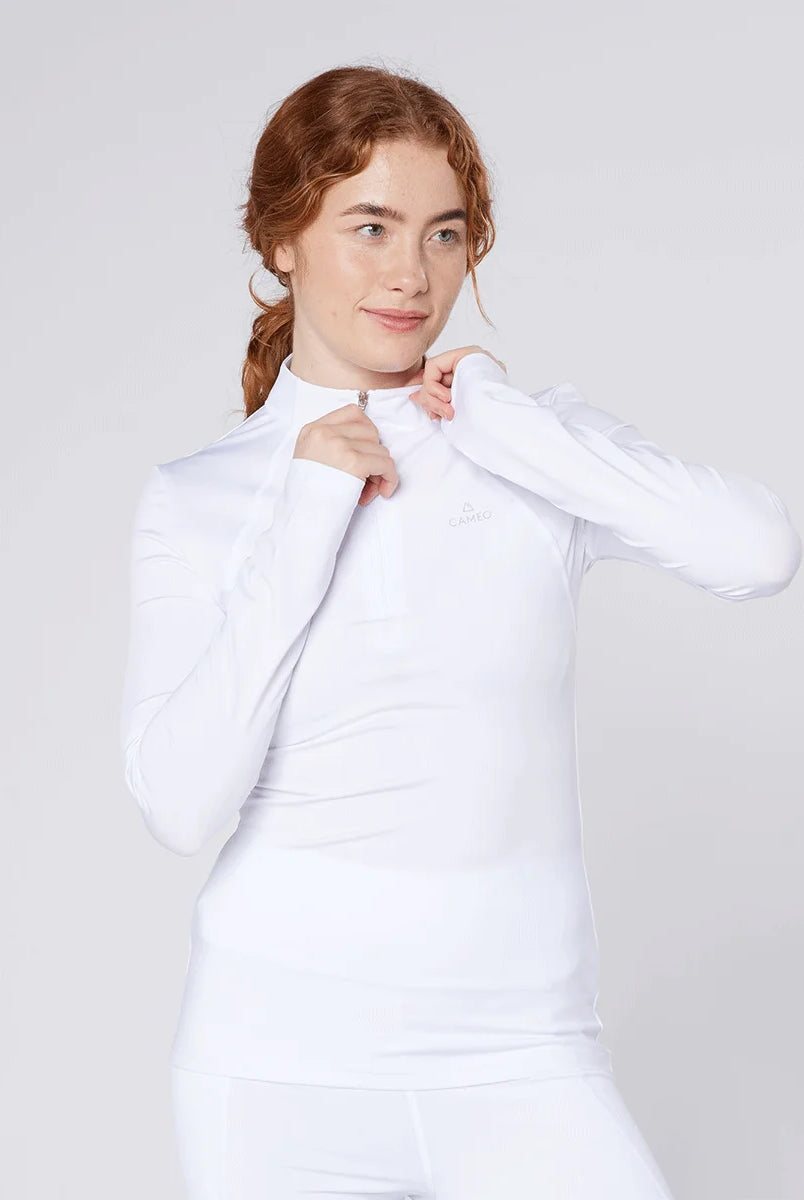 CAMEO Core Collection Baselayer in White worn by a rider, highlighting the adjustable quarter-zip stand collar and technical 360-degree stretch fabric. This high-performance equestrian competition top provides moisture-wicking comfort and a sleek, professional silhouette for UK riders.