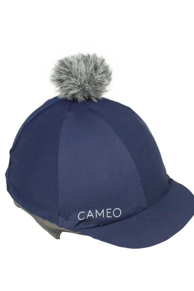 CAMEO Core Hat Silk in Indigo featuring a detachable grey faux-fur pom-pom and high-recovery CameoTech 4-way stretch fabric. This technical equestrian helmet cover is designed to provide a wrinkle-free fit over jockey skulls, complete with a flexible peak and secure elasticated hem for daily schooling or British competition.