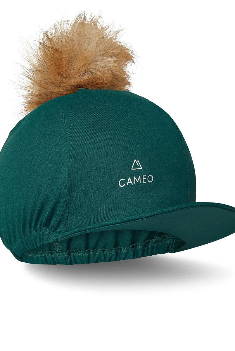 CAMEO Core Hat Silk in EverGreen featuring a detachable faux-fur pom-pom and 4-way stretch CameoTech performance fabric. Designed with a flexible peak and secure elasticated hem, this professional equestrian helmet cover provides a smooth, wrinkle-free fit for jockey skulls and riding hats in the UK.