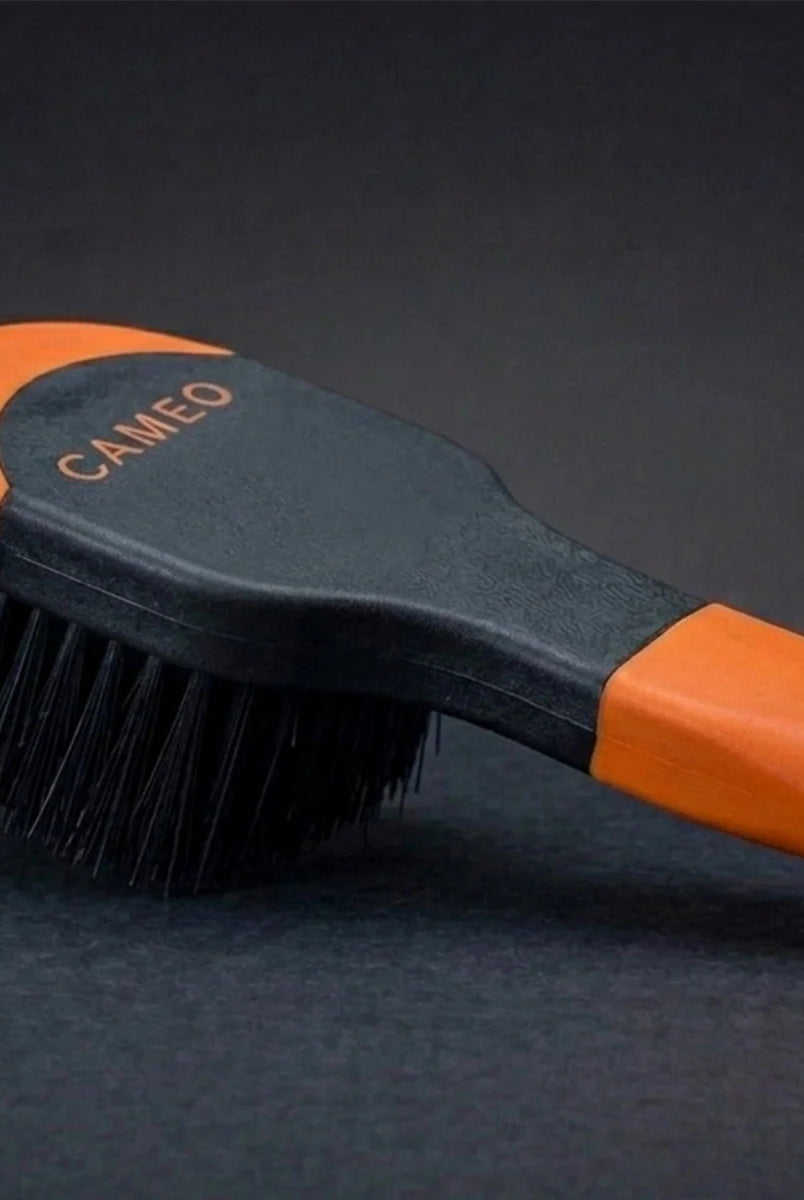 CAMEO Ergonomic Bucket Brush in Orange on a studio background featuring dense curved bristles for scrubbing stable feed buckets.