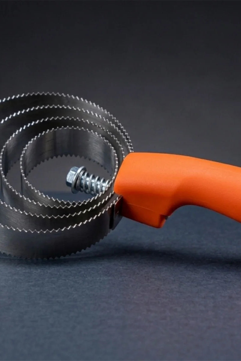 CAMEO Spring Metal Curry Comb in Orange on a studio background featuring circular serrated blades for removing caked mud.