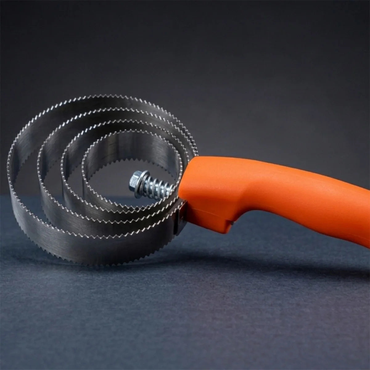 CAMEO Spring Metal Curry Comb in Orange on a studio background featuring circular serrated blades for removing caked mud.