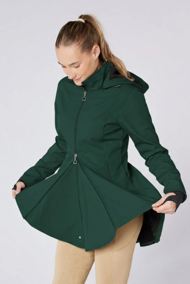 CAMEO Zenith Pro Ride Coat in EverGreen demonstrated by a model holding open the flared riding skirt, showcasing the two-way front zip, thermal fleece lining, and expansive saddle coverage engineered for unrestricted seat and leg aids in wet weather.