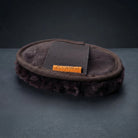 A dark brown faux-fur slouchy shoe cover with a dark brown canvas strap and an orange brand label reading '25 CAMEO', set against a dark gray background.