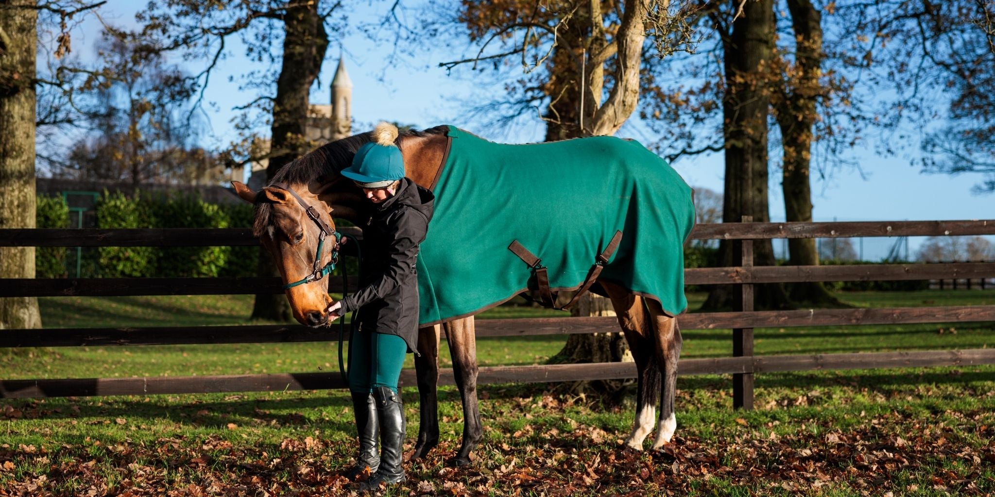 Horse and rider wearing the CAMEO AW 26 EverGreen collection, featuring a matching turnout rug, headcollar, riding tights, and waterproof coat
