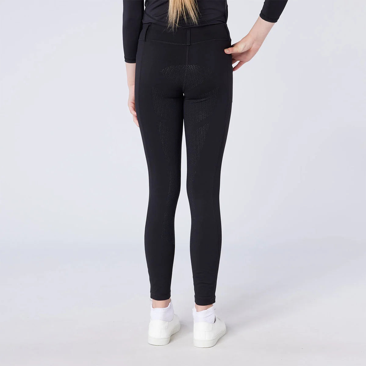 CAMEO All Season Riding Tights in Black worn by a junior rider, showcasing the innovative full-seat chevron silicone grip for maximum in-saddle stability. These technical equestrian leggings feature a high-rise core-supporting waistband and anti-chafing flat-lock seams for professional UK performance.