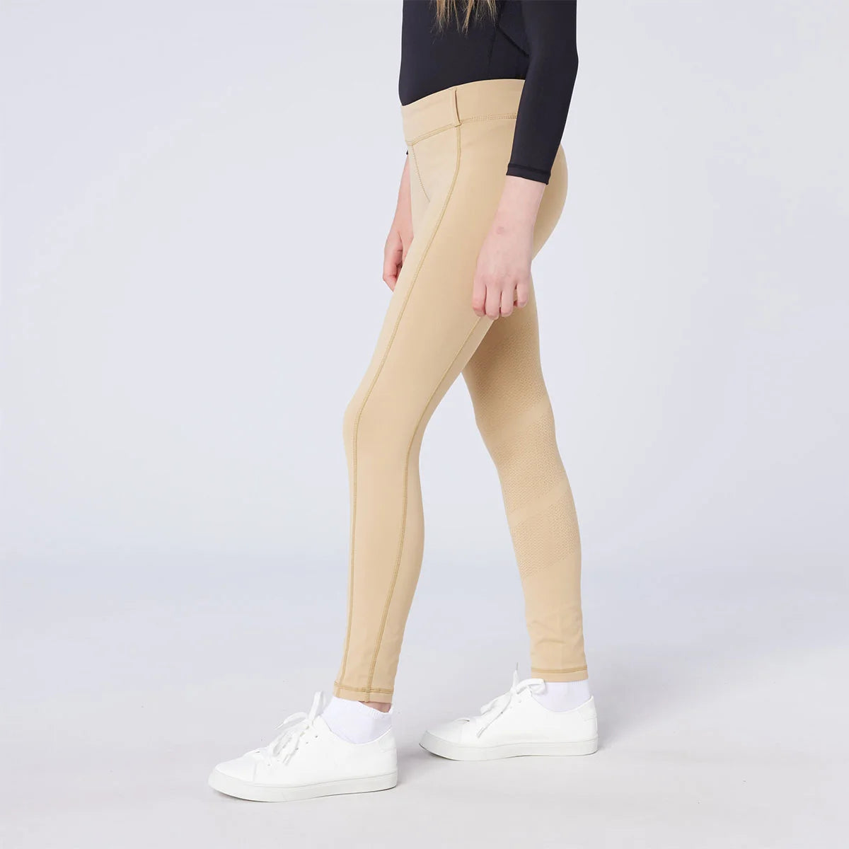 CAMEO All Season Riding Tights in Beige worn by a junior rider, featuring an innovative full-seat silicone chevron grip for elite in-saddle stability. These technical equestrian leggings provide 4-way compression stretch, a high-rise waistband, and a thermal brushed lining for all-weather riding.