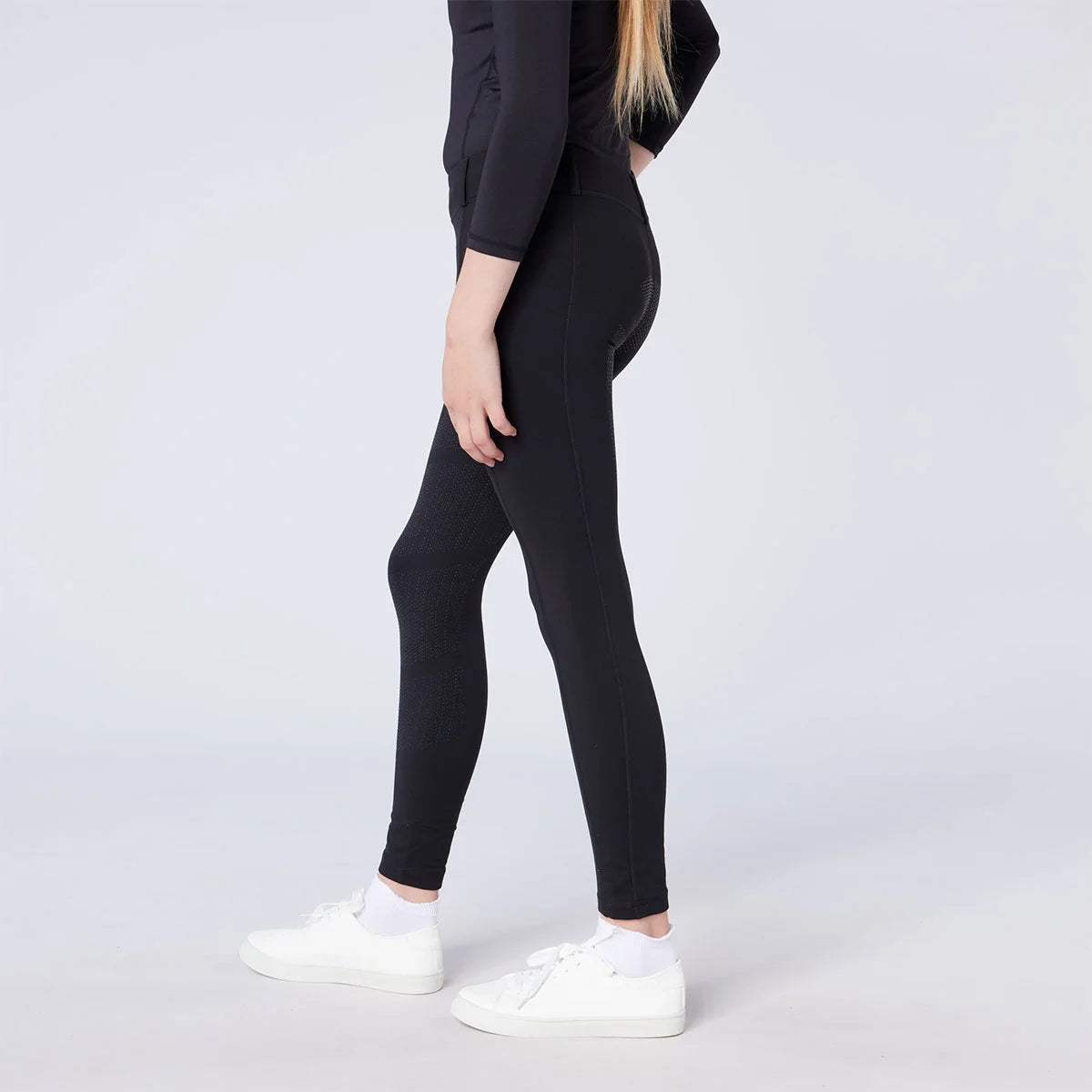 CAMEO All Season Riding Tights in Black worn by a junior rider featuring an innovative full-seat silicone chevron grip for maximum in-saddle stability. These technical equestrian leggings provide thermal brushed microfibre warmth, 4-way compression stretch, and a high-rise core-supporting waistband.