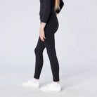 CAMEO All Season Riding Tights in Black worn by a junior rider featuring an innovative full-seat silicone chevron grip for maximum in-saddle stability. These technical equestrian leggings provide thermal brushed microfibre warmth, 4-way compression stretch, and a high-rise core-supporting waistband.