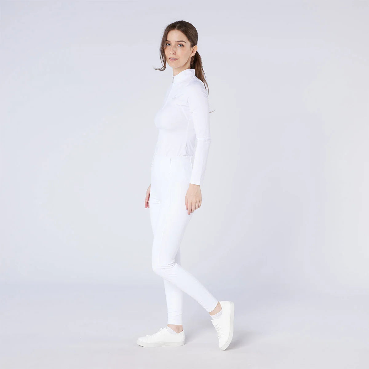 CAMEO All Season Tights in White worn by a rider for British equestrian competition featuring a high-rise core-supporting waistband and 4-way compression stretch. These technical show tights include an innovative full-seat silicone chevron grip and thermal brushed lining for professional performance.