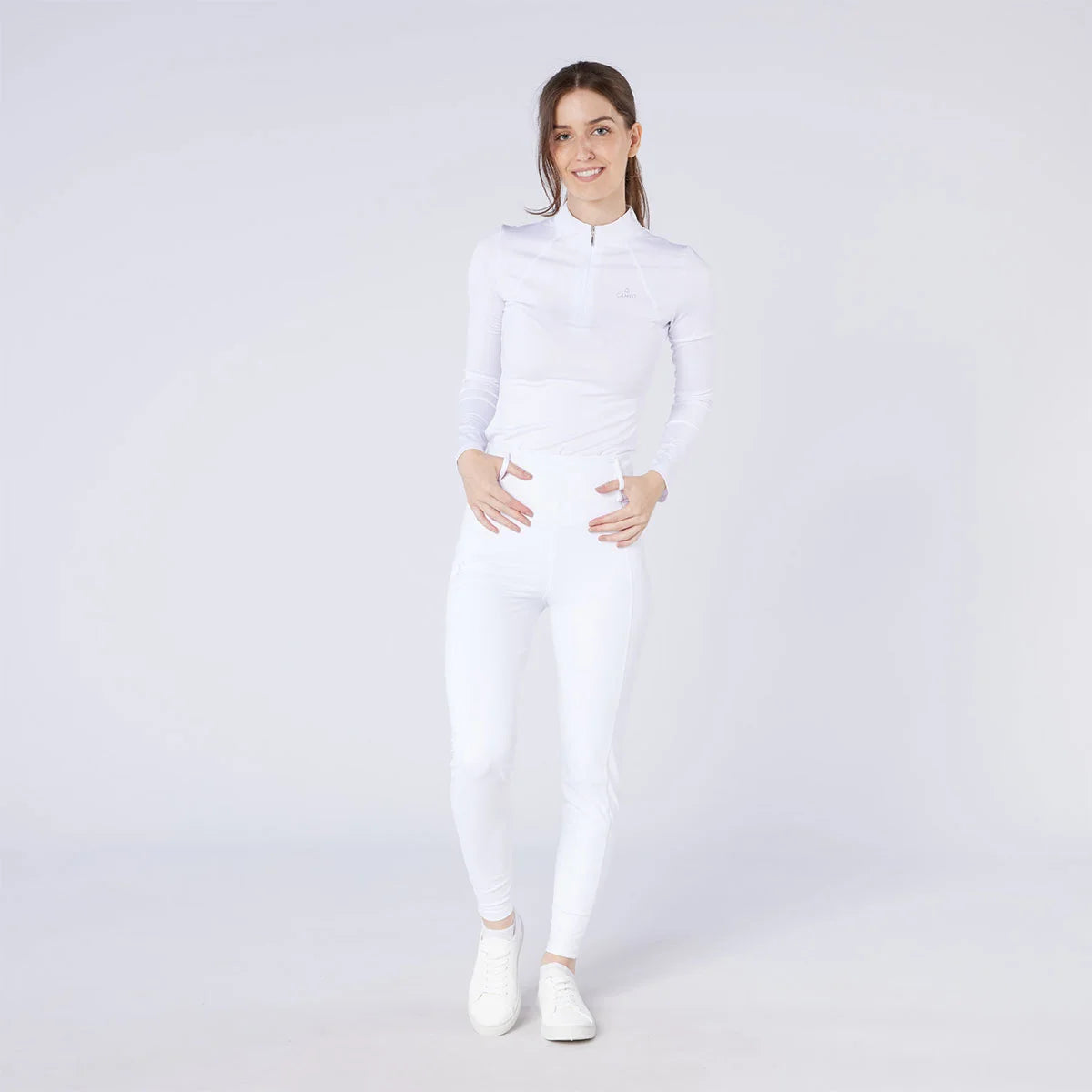 CAMEO All Season Tights in White worn by a rider for British equestrian competition. These technical show tights feature a high-rise core-supporting waistband, 4-way compression stretch, and an innovative full-seat silicone chevron grip for maximum security and professional performance.