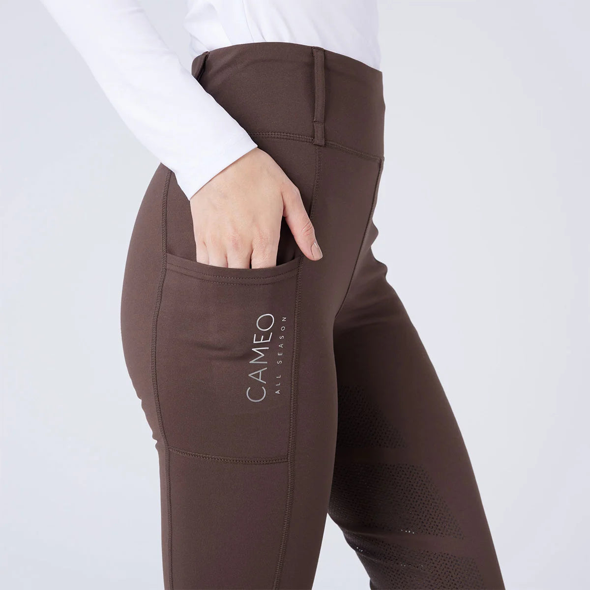 CAMEO All Season Tights in Chocolate Brown featuring a deep ergonomic thigh smartphone pocket and high-rise core-supporting waistband. These technical equestrian riding tights are designed with 4-way compression stretch, thermal brushed lining, and reinforced belt loops for elite performance.