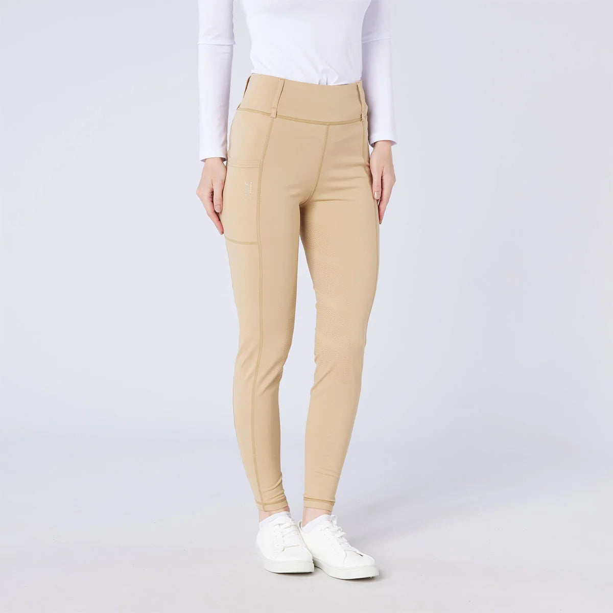 CAMEO All Season Tights in Beige featuring a high-rise core-supporting waistband and a deep ergonomic thigh smartphone pocket. These technical equestrian riding tights are engineered with a full-seat chevron silicone grip, thermal brushed lining, and 4-way compression stretch for professional UK riders.