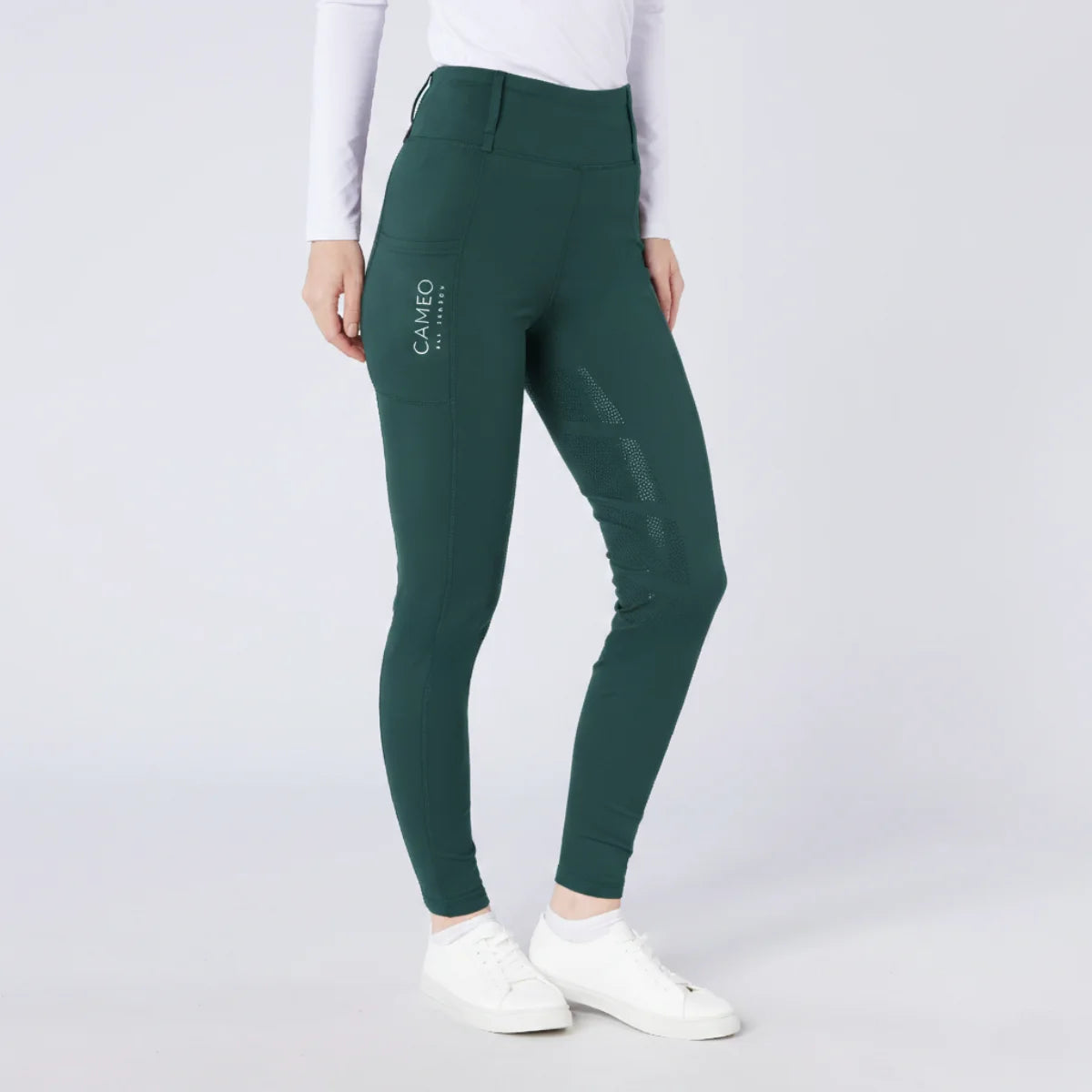 CAMEO All Season Tights in EverGreen featuring a high-rise core-supporting waistband and a deep ergonomic thigh smartphone pocket. These technical equestrian riding tights are engineered with a full-seat chevron silicone grip, thermal brushed lining, and 4-way compression stretch for professional UK riders.