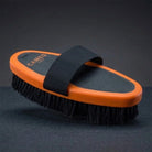 CAMEO Body Brush in Orange on a studio background highlighting the ergonomic oval block and uniform bristle trim.