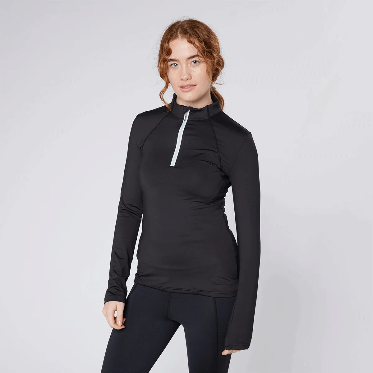CAMEO Core Collection Baselayer in Black featuring a contrast white quarter-zip and technical 4-way stretch CameoTech fabric. This professional equestrian top is designed with a tailored silhouette, ergonomic flat-lock seams, and active moisture-wicking properties for high-performance riding in the UK.