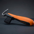 CAMEO Hoof Pick with Brush in Orange with an ergonomic grip handle and durable pick head on a studio background.